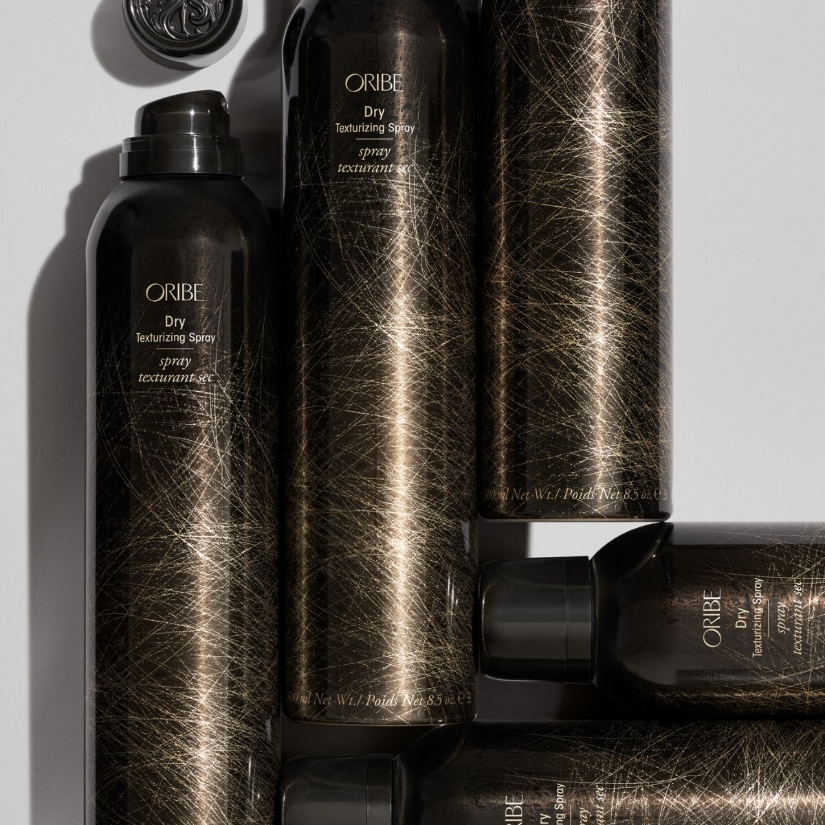 Oribe Dry Texturizing Spray – Angled View of 4 Bottles for Volumizing, Textured Hair
