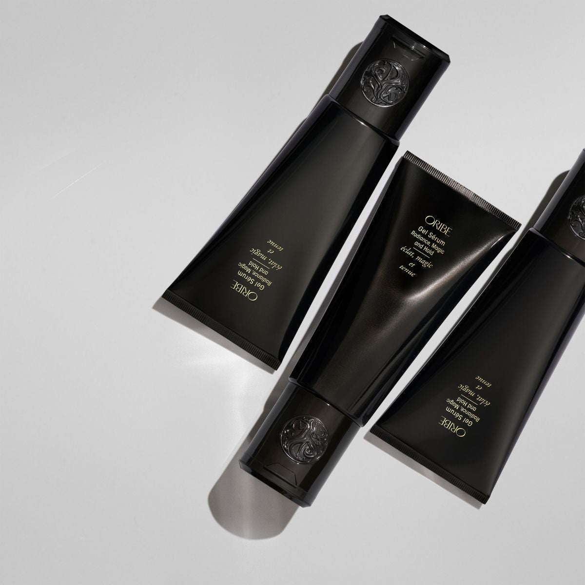 Oribe Gel Serum – Luxury Haircare Styling Gel, Photo of Three Tubes Angled for Display
