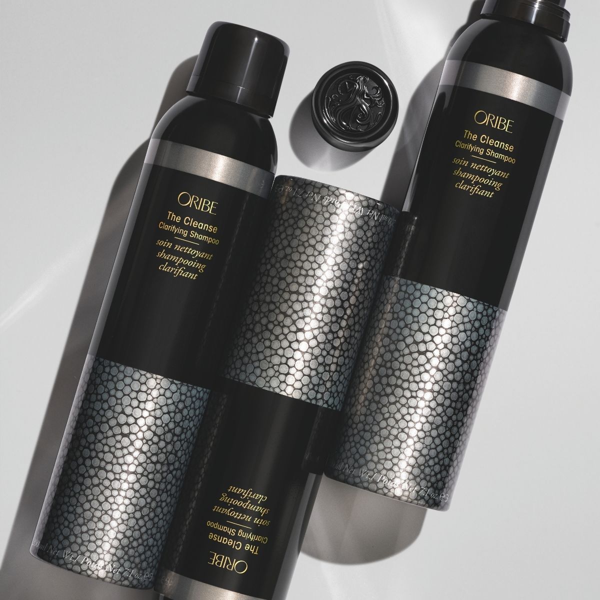 Oribe The Cleanse Clarifying Shampoo – Angled View Showing 3 Bottles, Deep Cleansing Haircare